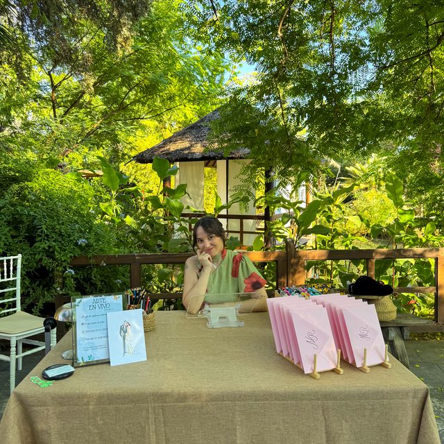 Stand de ilustración en directo de DELUNA en el jardín de una boda